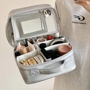 Detail view of the silver PU makeup bag interior with mirror and adjustable dividers