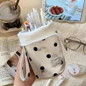 Detailed view of the high-capacity polka dot pencil case filled with various stationery