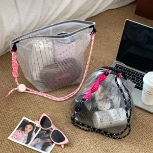 Close-up of EVA waterproof mesh bags with vibrant pink and black braided rope handles