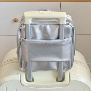 Metallic silver PU makeup organizer bag with trolley sleeve attached to suitcase handle