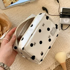 Detailed macro shot of large capacity white polka dot pencil case with butterfly patches