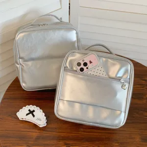 Detailed view of silver metallic PU travel cosmetic bags with convenient front pockets