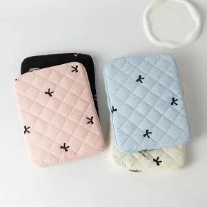 Quilted laptop sleeves with embroidered bows in multiple colors for 11 to 15 inch devices
