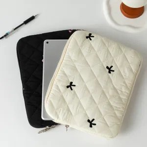 Cute quilted laptop sleeve with bow embroidery showing black and cream options
