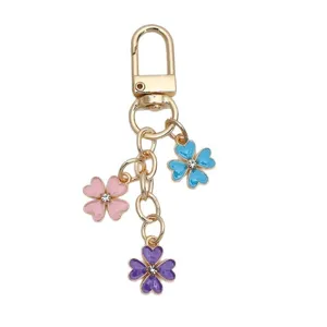 Colorful enamel flower keychain with pink, blue, purple charms on gold metal chain