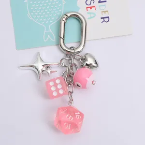 Macro view of creative pink lucky dice and heart charms on a silver keychain detail