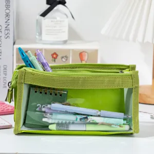 Close-up view of a green large capacity mesh pencil bag with various pens inside