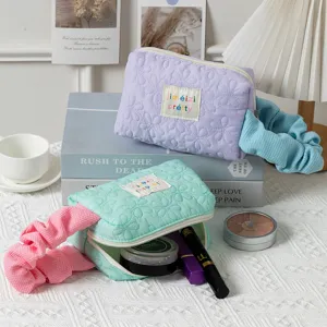 Quilted candy-colored floral makeup bag with scrunchie handle for cosmetic storage