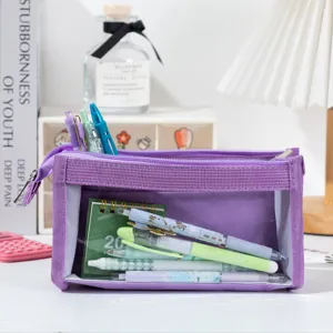 Macro view of a purple mesh pencil case showing its transparent window and inner pens