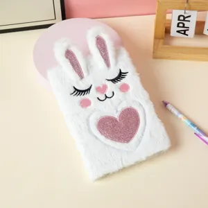Detailed macro shot of white plush A5 notebook featuring cute embroidered rabbit face