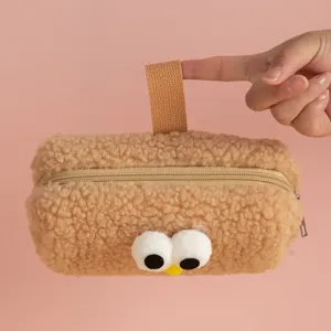 Plush brown pencil case with cute cartoon eyes and handle detail