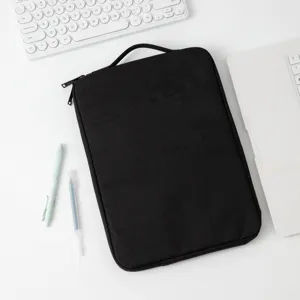 Detailansicht einer schwarzen Laptoptasche mit Griff auf einem sauberen weißen Schreibtisch