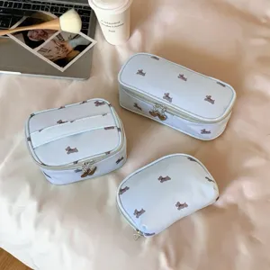 Three-piece set of light blue puppy print travel cosmetic bags with heart zippers