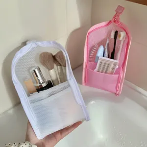 Compact mesh travel toiletry bags for toothbrushes and makeup tools in a bathroom setting