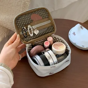 Open puppy pattern makeup bag showing internal storage capacity with cosmetics