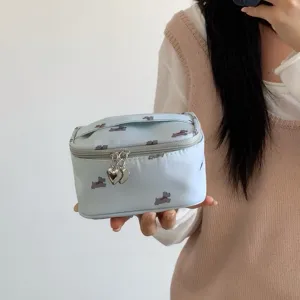 Light blue portable cosmetic bag with cute dog pattern and heart-shaped zippers