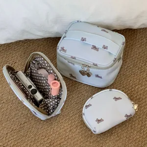 Detail view of dog print makeup bags showing interior storage and different sizes