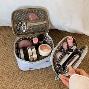 Detail view of dog print travel makeup bag showing interior compartments and organizers