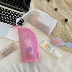 Detail of pink and white portable mesh storage bags for toiletries and travel