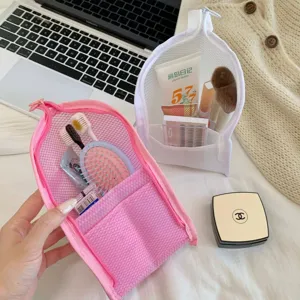 Detailed view of mesh travel toiletry bags holding brushes, sunscreen, and accessories.