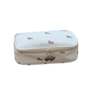 White travel cosmetic bag with cute brown puppy pattern and heart-shaped metal zipper pull