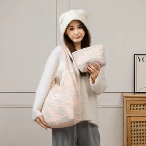 Asiatisches Model mit Bärenmütze trägt eine süße gestrickte Pastell-Tragetasche und Etui