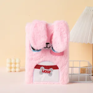 Close-up detail of a soft pink plush cartoon bunny notebook with embroidered ears