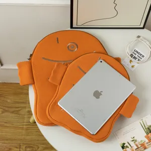 Ugly-cute orange fish-shaped iPad sleeve with soft fabric texture and size comparison