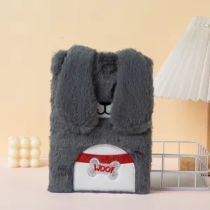 Detail showing texture of gray plush cartoon notebook with floppy ears and WOOF embroidery