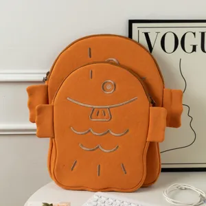 Cute Taiyaki-shaped orange laptop and tablet sleeves in two sizes on desk