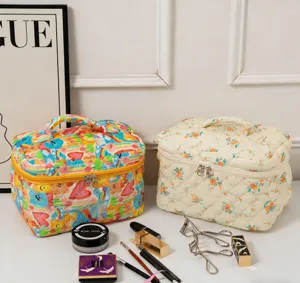 Large quilted cosmetic storage bags featuring cute floral and heart patterns with makeup props