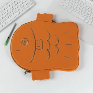 Detailed macro view of a cute orange Taiyaki fish-shaped padded laptop sleeve for tablets