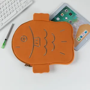 Detailed view of cute orange fish-shaped iPad sleeve on a desk with tech accessories