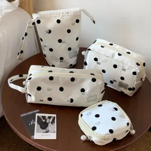 Detailed view of polka dot stationery pouch set with pearl zipper charms.