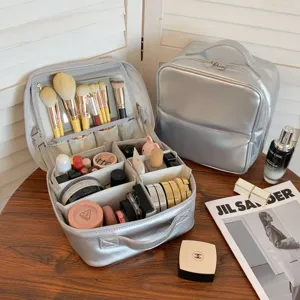 Silver PU makeup bag detail showing interior compartments and brush storage with mirror