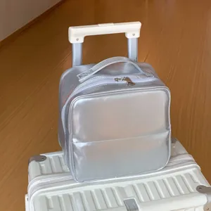 Detail of a silver PU leather travel makeup bag featuring a creative mini trolley handle design