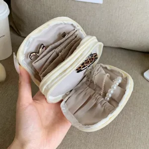 Detail of internal compartments in a cream multi-functional stationery pouch