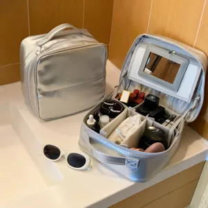Silver PU cosmetic bag with adjustable compartments and built-in mirror for travel