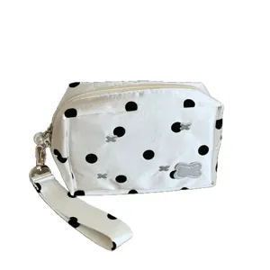 Stylish white and black polka dot pencil case with large capacity and portable wristlet