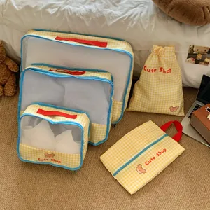 Cozy display of yellow checkered travel mesh organizer set for suitcase packing