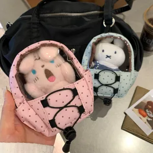 Close-up of a pink polka dot mini backpack doll carrier keychain with clear window