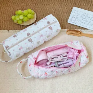 Quilted cartoon storage bag showing interior space for hair dryer and hair straightener