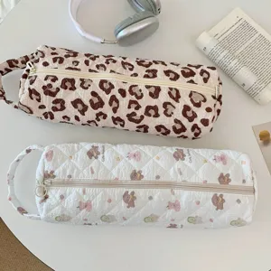 Detailed view of quilted storage bags with leopard print and cute animal patterns