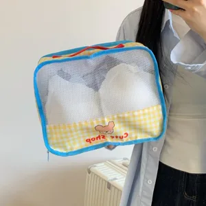 Yellow checkered mesh travel storage bag for organizing underwear and clothes