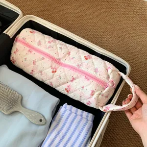 Pink quilted floral hair dryer storage bag organized inside a travel suitcase bag