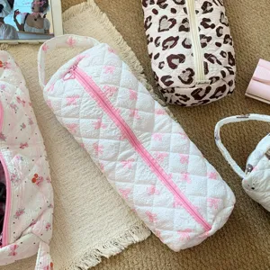 Large quilted storage bag with pink bow pattern for hair dryer and curling iron