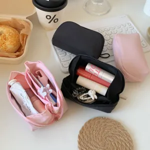 Close-up of open mini cosmetic pouches showing organized lipsticks and accessories
