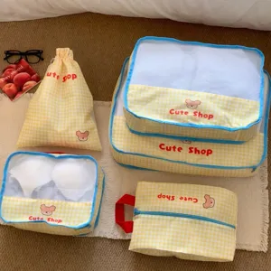 Detailed view of yellow gingham mesh travel organizer set featuring cute bear pattern