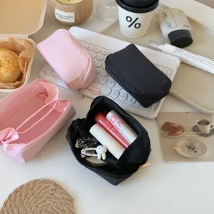 Close-up view of mini portable lipstick pouch with multi-compartment internal divider design