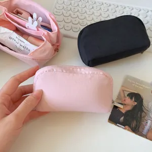 Internal compartments of the mini pink cosmetic pouch with daily essentials